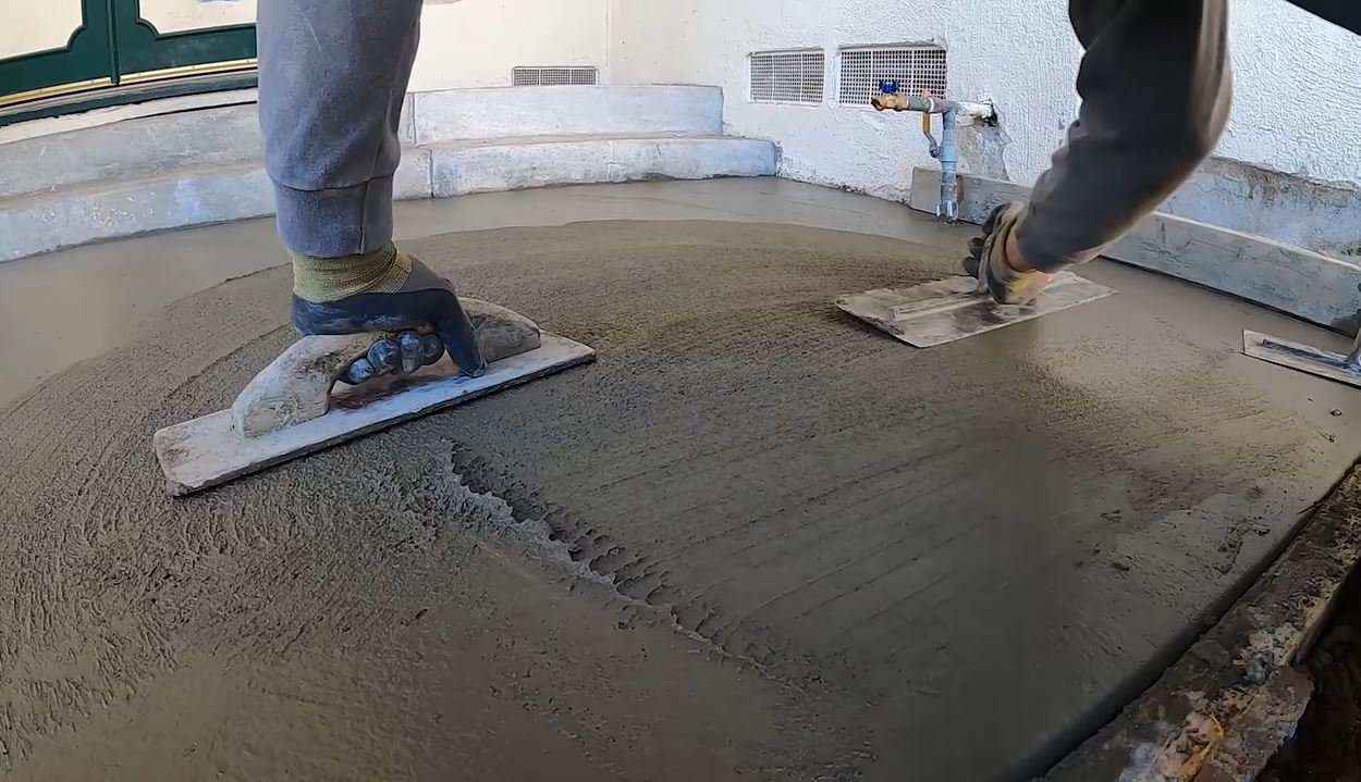 hand troweling concrete finish professional mason smoothing surface